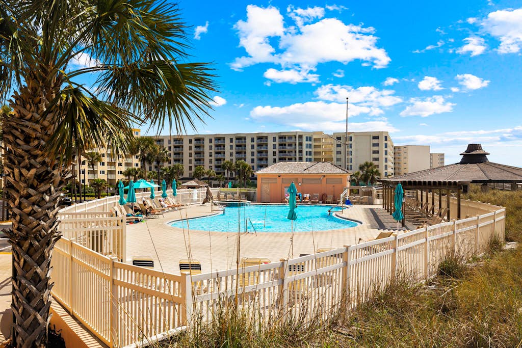 Bright ocean-view condo with community pool and direct beach walkway