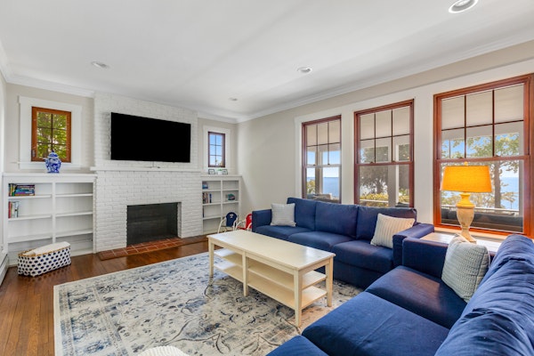 Waterfront home with scenic porches, yard, grill, jetted tub, central AC, & W/D