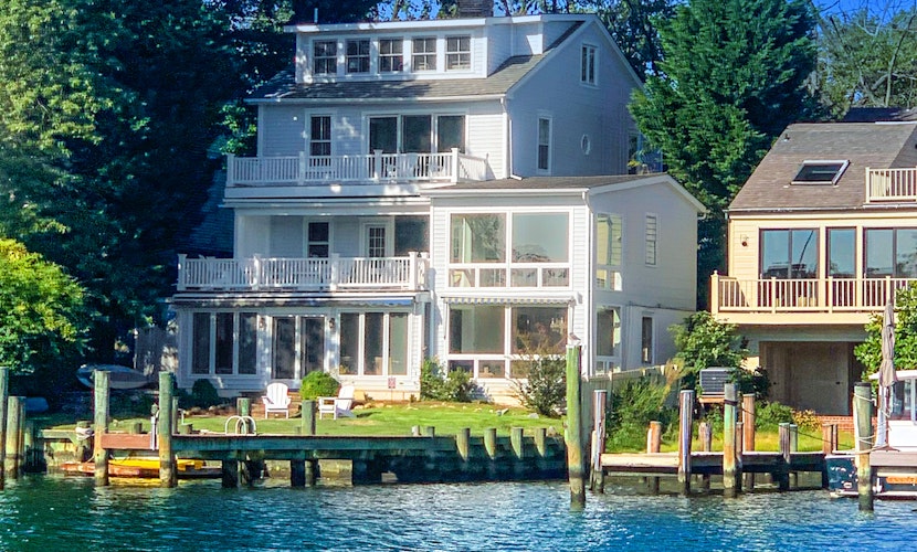 Dog-friendly riverfront home with dock, 2 balconies, waterside patio, & grill