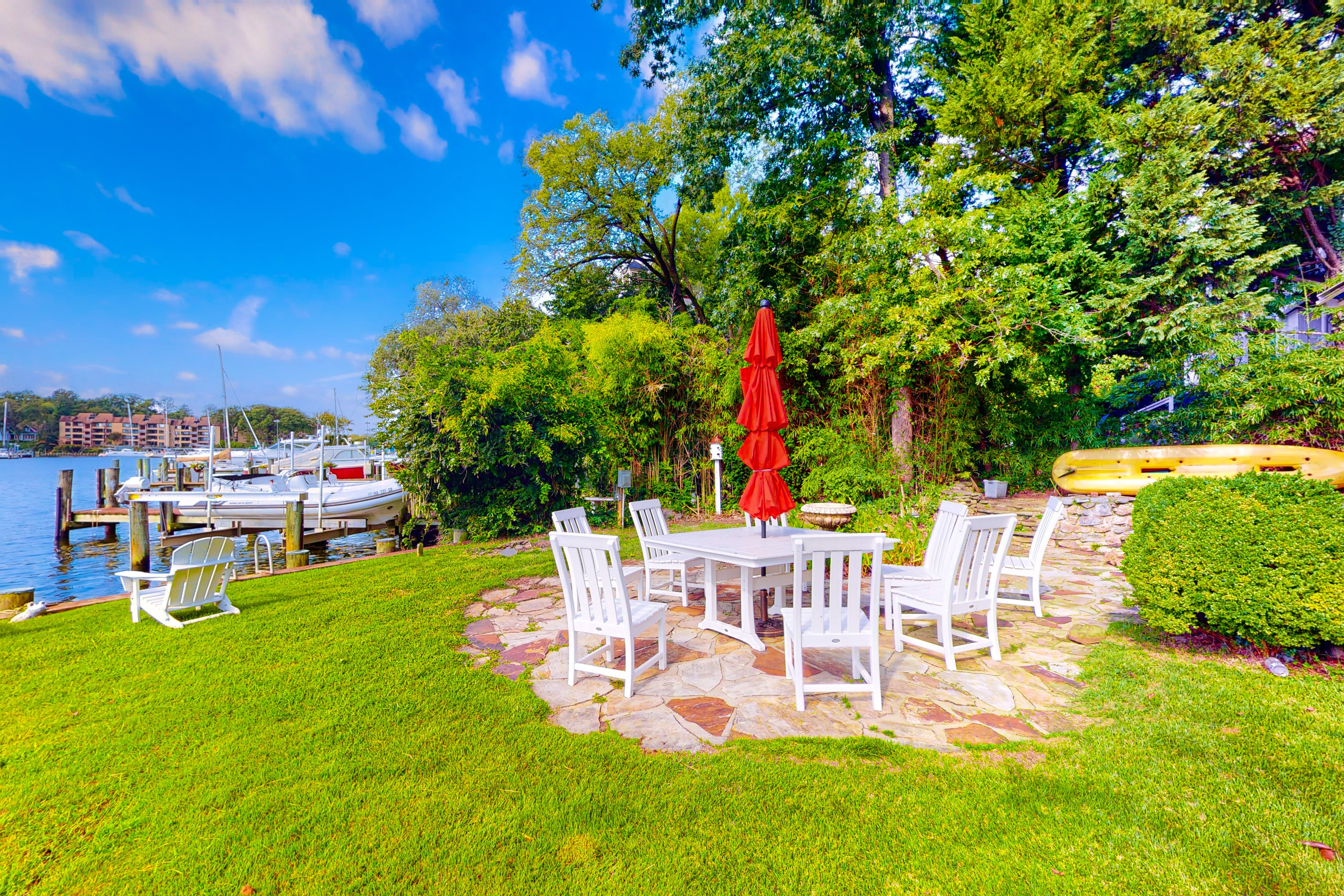 Dog-friendly riverfront home with dock, 2 balconies, waterside patio, & grill