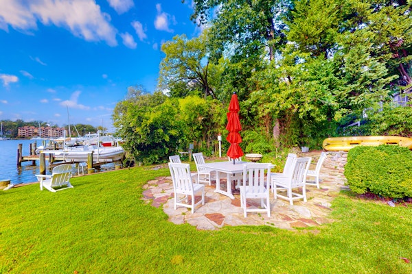 Dog-friendly riverfront home with dock, 2 balconies, waterside patio, & grill