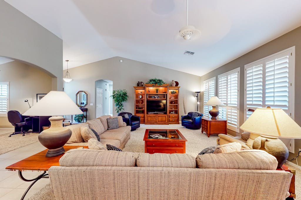 Palm-lined home with pool access, grill, office & golf course views