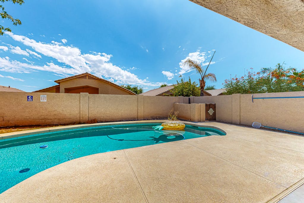 Updated home with private pool, enclosed yard, covered patio, grill, & W/D