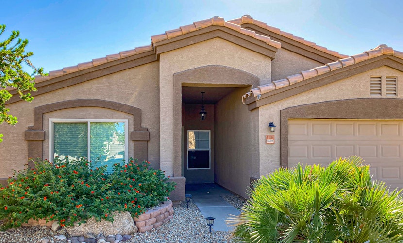 Spacious desert home with hot tub, covered patio, grill, & modern finishes