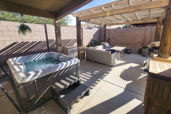 Spacious desert home with hot tub, covered patio, grill, & modern finishes