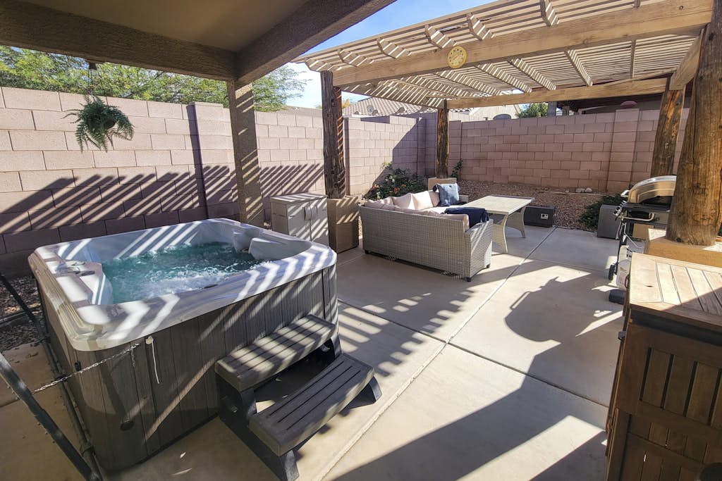 Spacious desert home with hot tub, covered patio, grill, & modern finishes