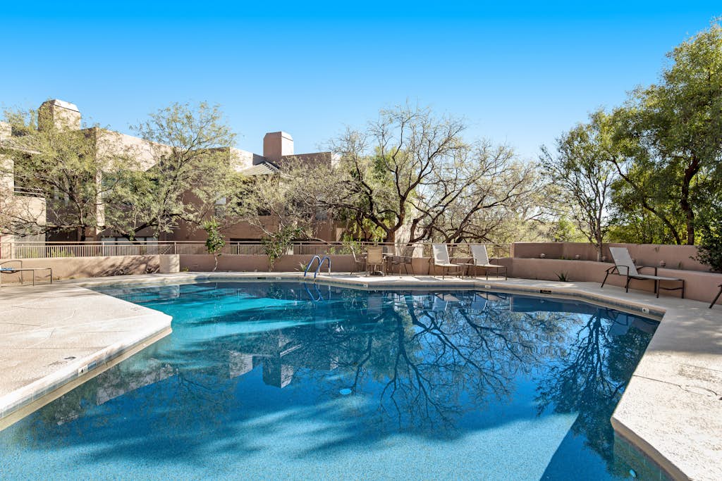 Radiant retreat with pool and hot tub access, sunroom, washer/dryer, gym, & AC