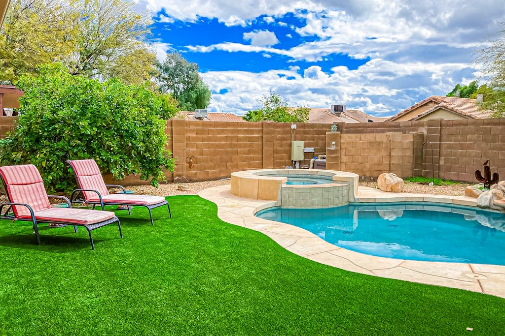 Desert charmer with enclosed yard, heated pool, smart TVs, W/D, & full kitchen