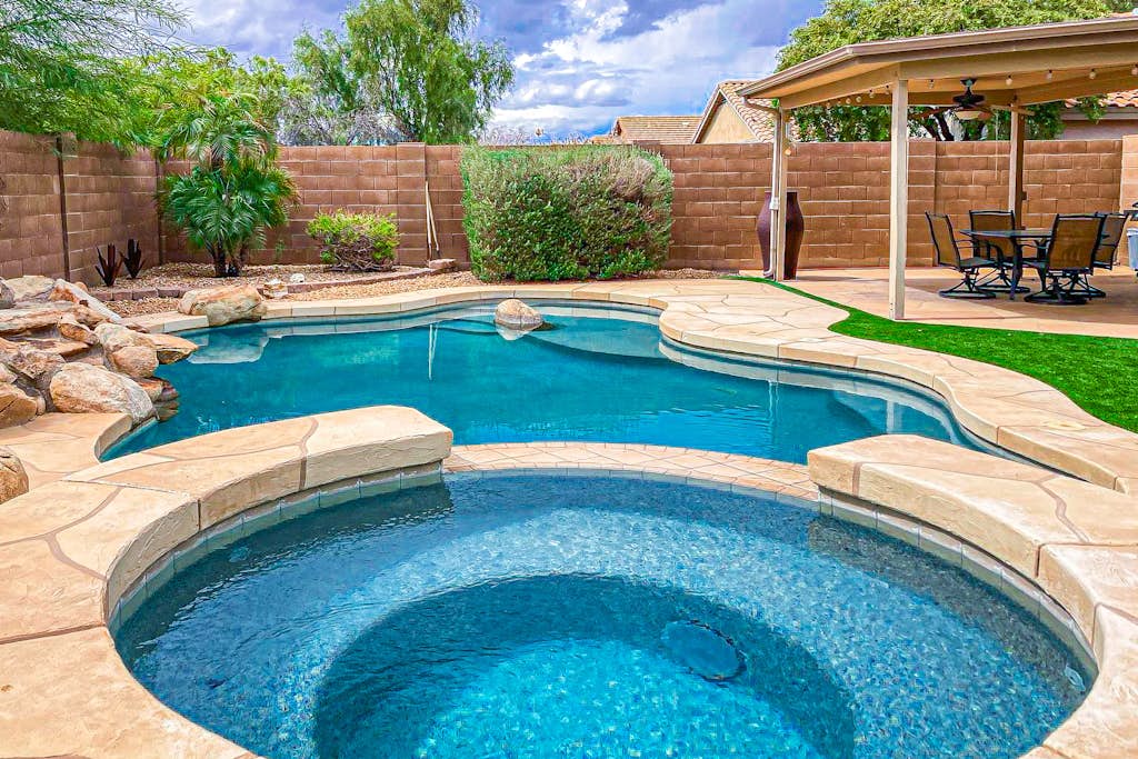 Desert charmer with enclosed yard, heated pool, smart TVs, W/D, & full kitchen