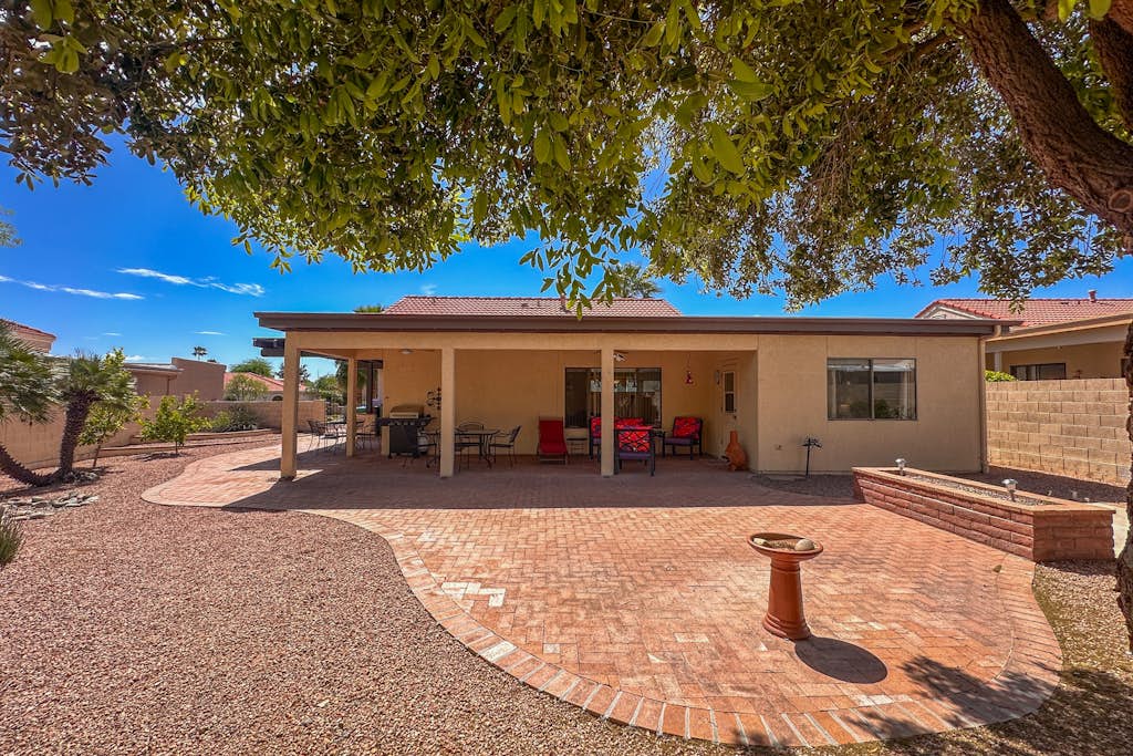 Mountain-view home with shaded patio, large yard, on-site golf & tennis
