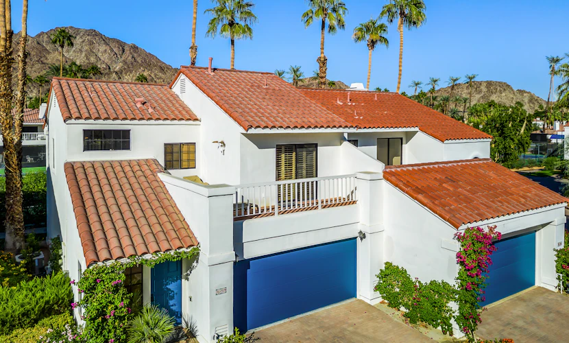 Palm-lined mountain view condo with heated pool, tennis, grill, fireplace, & AC