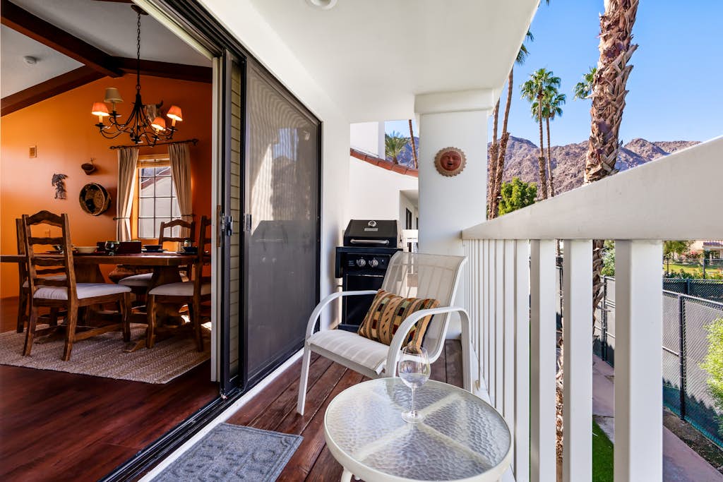 Palm-lined mountain view condo with heated pool, tennis, grill, fireplace, & AC