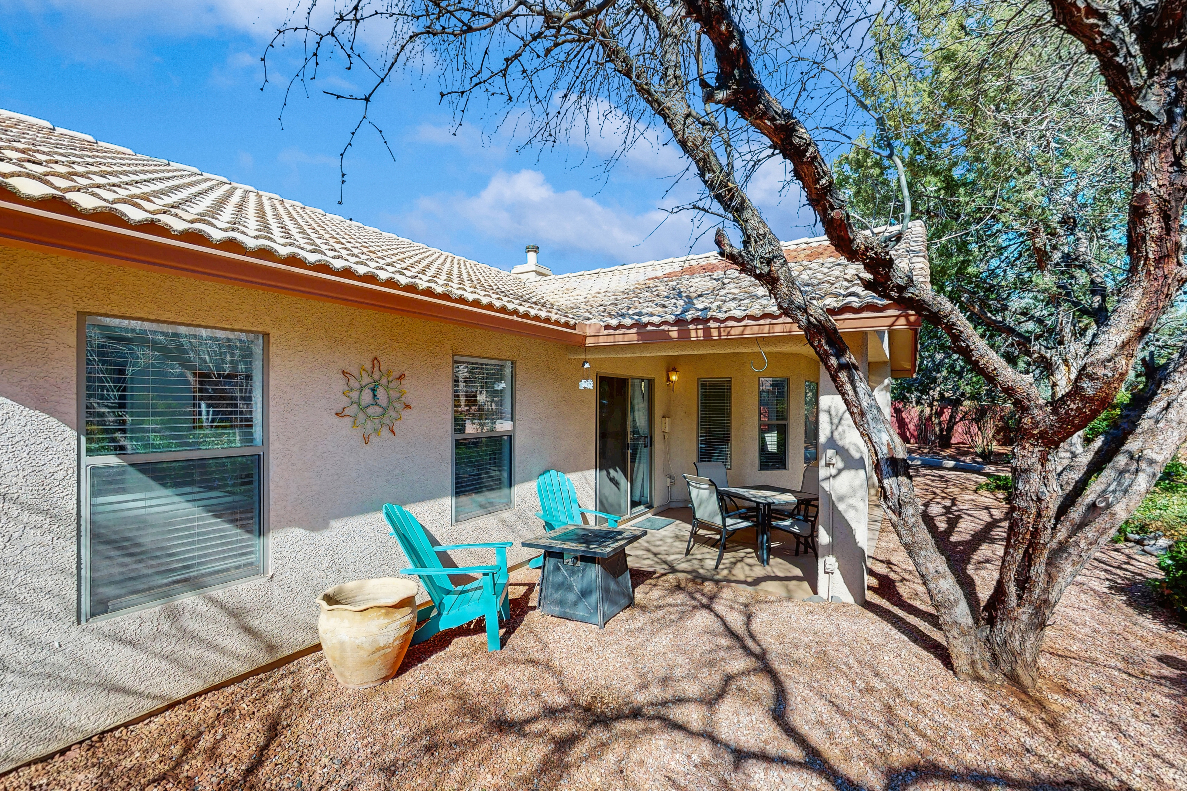 Dog-friendly home with garden patio, fireplace, & views of red rock cliffs
