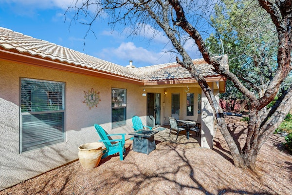 Dog-friendly home with garden patio, fireplace, & views of red rock cliffs