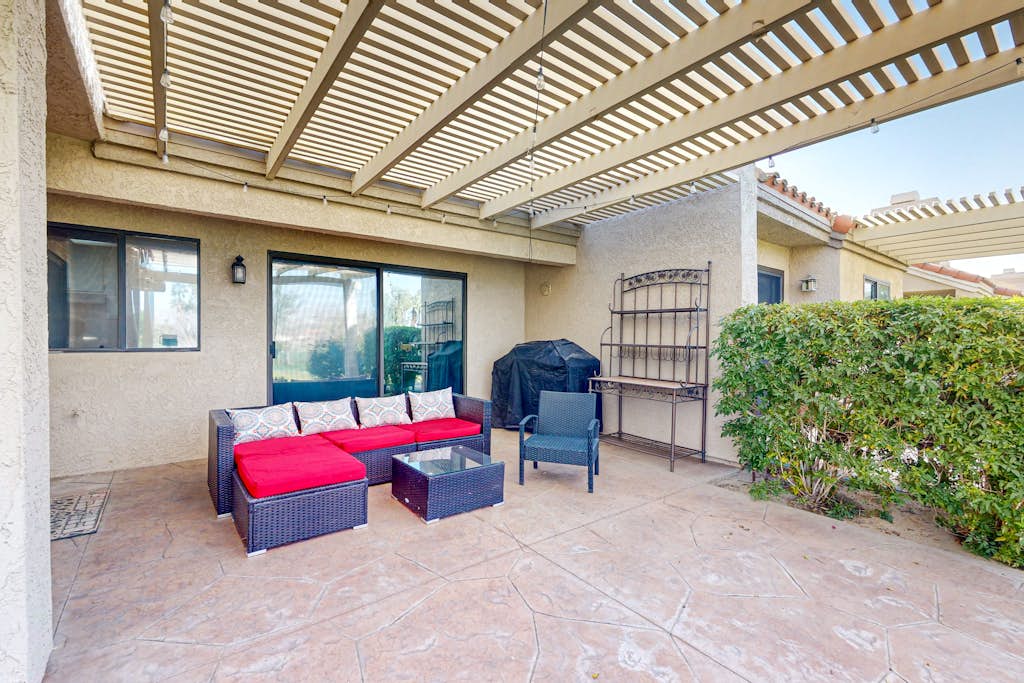 Water-view home on golf course with hot tub, pool, tennis, on-site golf, & patio