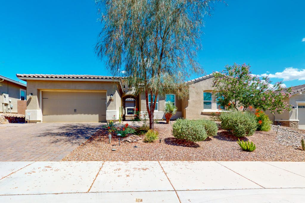 Southwestern stunner with enclosed yard, pool, putting green, & grill