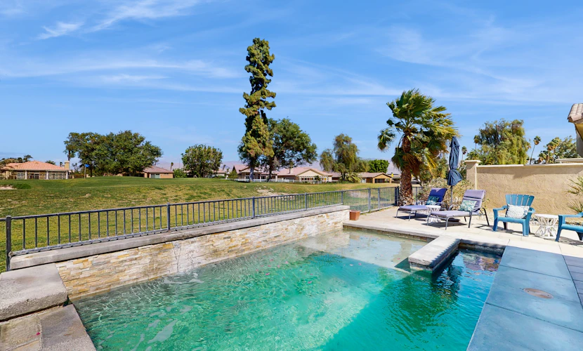 Dog-friendly golf course-adjacent home with a private pool, pool spa, & AC
