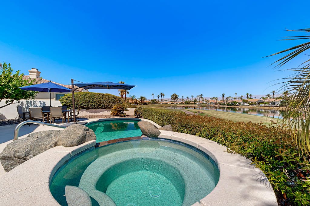 Waterfront, golf-view home w/ a private pool, pool spa, & outdoor dining area