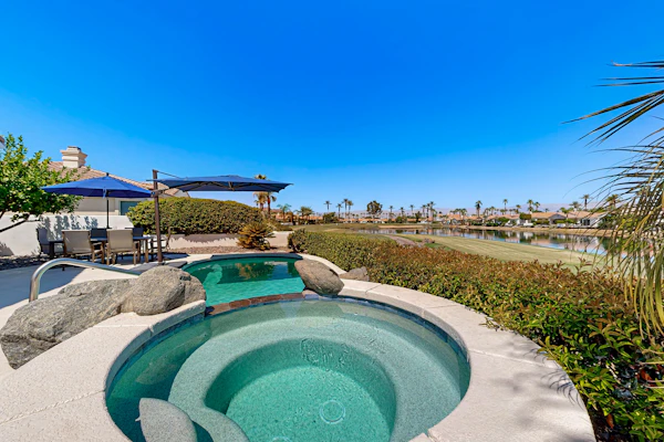 Waterfront, golf-view home w/ a private pool, pool spa, & outdoor dining area