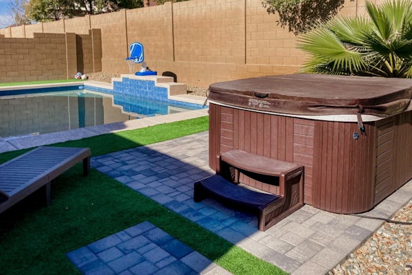 Single-story home with enclosed yard, private pool, hot tub, patio, & grill