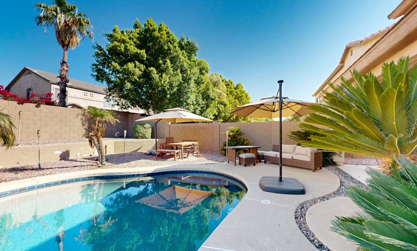 Spacious home surrounded by palms with pool, grill, children's items, & W/D