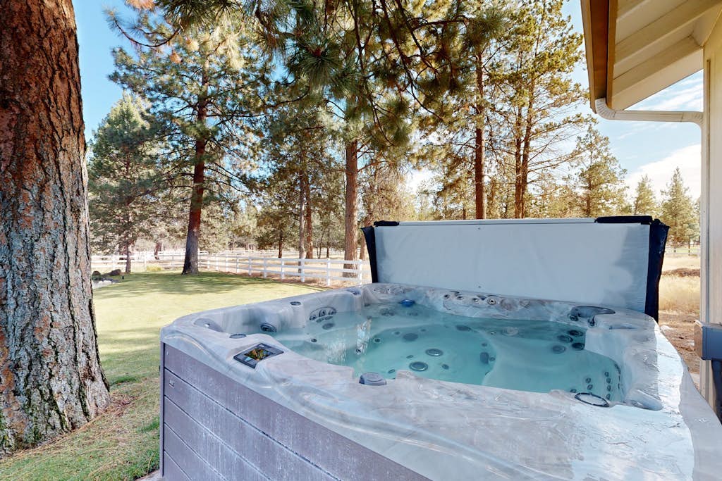 Tree-lined retreat with a hot tub, grill, game room, & W/D - mountain views