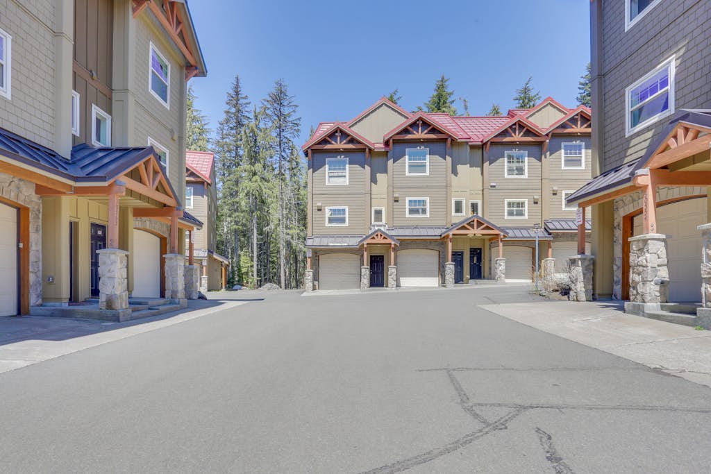 Riverfront mountain townhouse with pool & hot tub, patio, & easy ski access