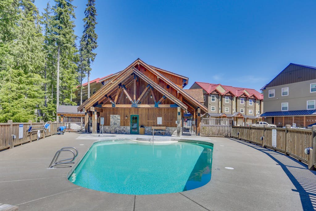 Riverfront mountain townhouse with pool & hot tub, patio, & easy ski access