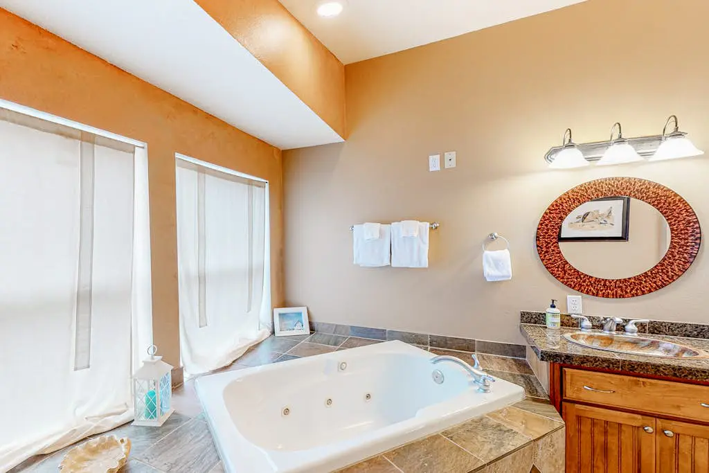 Dog-friendly sound-front cottage with fireplace, deck, lawn, beach access, & W/D