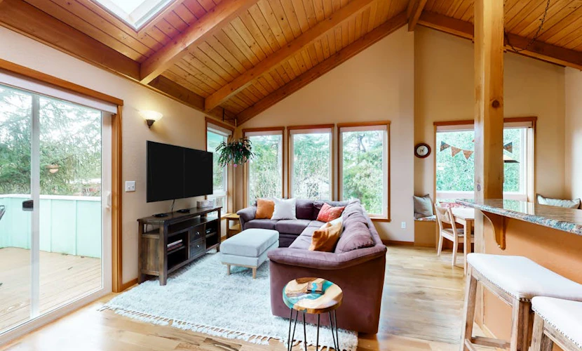 Tree-lined coastal home with wood fireplace, yard, W/D, & games - dog-friendly