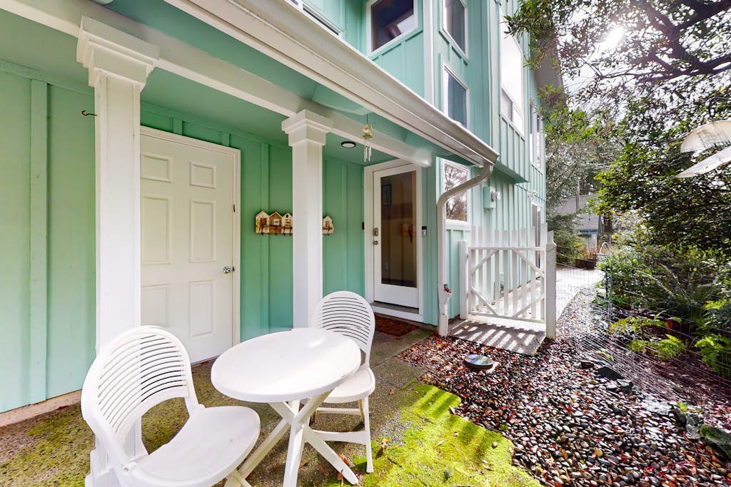 Tree-lined coastal home with wood fireplace, yard, W/D, & games - dog-friendly