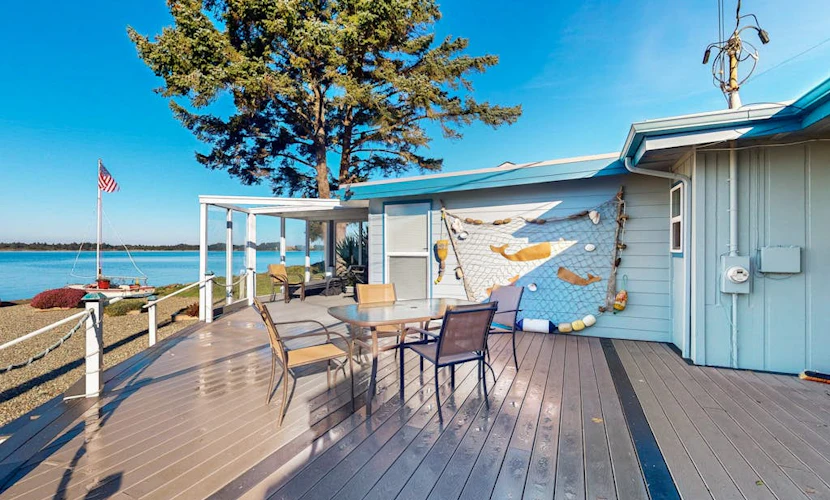 Waterfront home with panoramic bay views, deck, fireplace & beach access