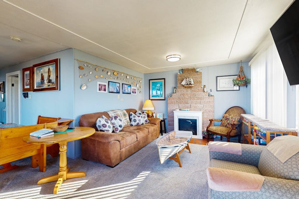 Waterfront home with panoramic bay views, deck, fireplace & beach access