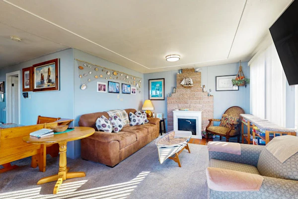 Waterfront home with panoramic bay views, deck, fireplace & beach access