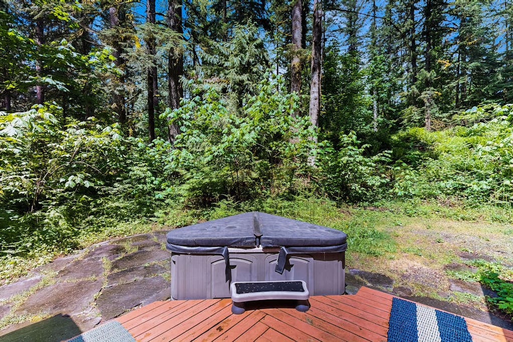 Cozy Riverfront Cottage with Charming Interior & Hot Tub - Dog-Friendly