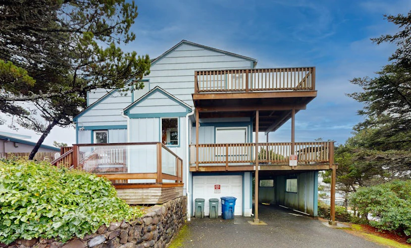 Comfy duplex with peekaboo ocean views, private hot tub, & easy beach access
