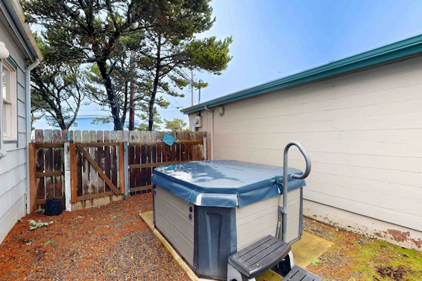 Comfy duplex with peekaboo ocean views, private hot tub, & easy beach access