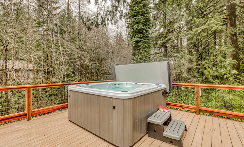 Classic forest cabin on Still Creek with private hot tub & wood fireplace