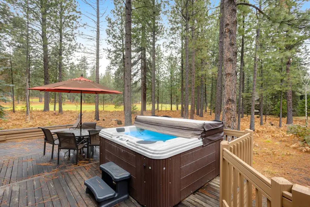Forested getaway with kitchen, stone fireplace, pool, & private hot tub