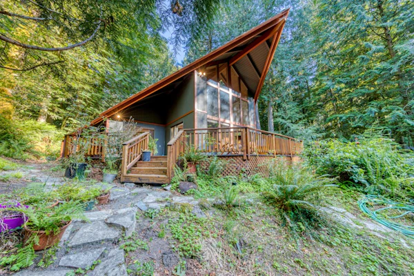 Creekside home with hot tub, deck, & great woodland views