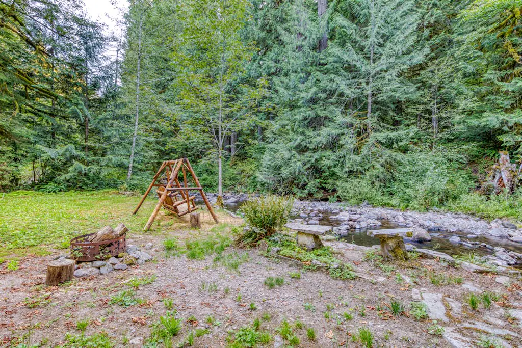 Creekside home with hot tub, deck, & great woodland views