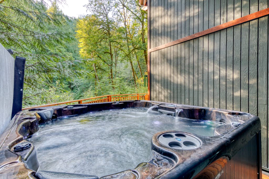 Creekside home with hot tub, deck, & great woodland views