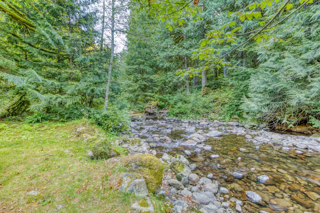 Creekside home with hot tub, deck, & great woodland views