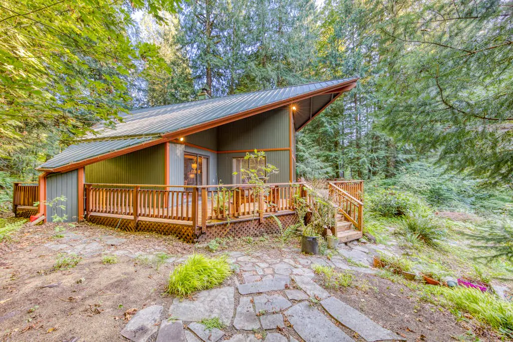 Creekside home with hot tub, deck, & great woodland views
