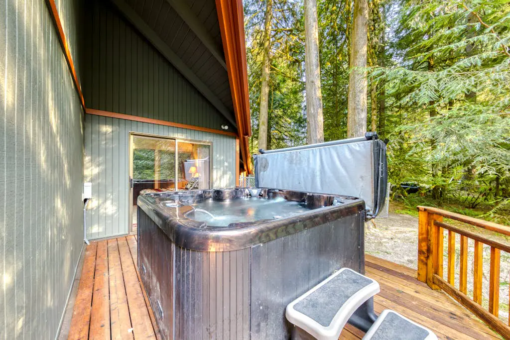 Creekside home with hot tub, deck, & great woodland views