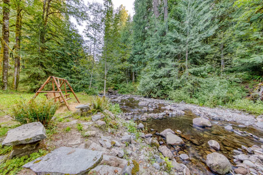 Creekside home with hot tub, deck, & great woodland views