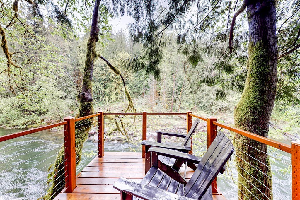 Unwind in nature's embrace at a 1925 cabin with hot tub & river views