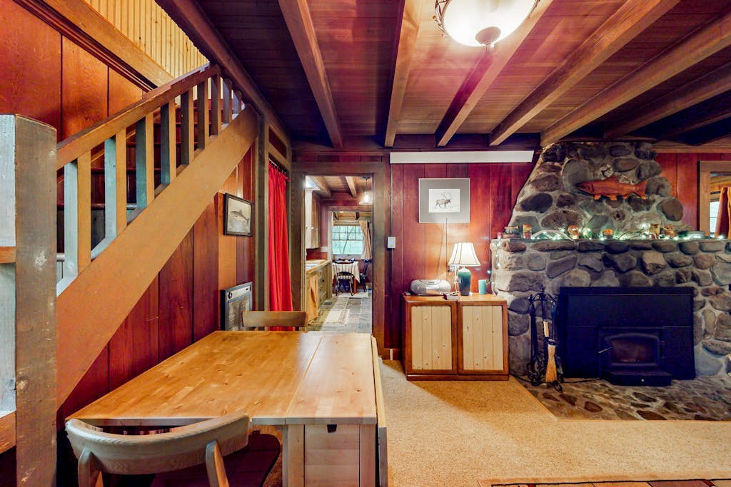 Unwind in nature's embrace at a 1925 cabin with hot tub & river views