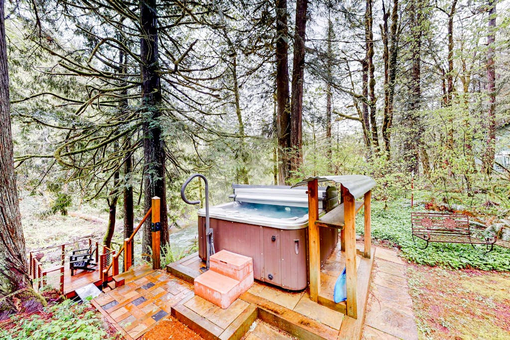 Unwind in nature's embrace at a 1925 cabin with hot tub & river views