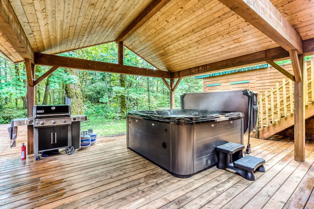 Dog-friendly creekside home with entertainment barn, private hot tub & firepit